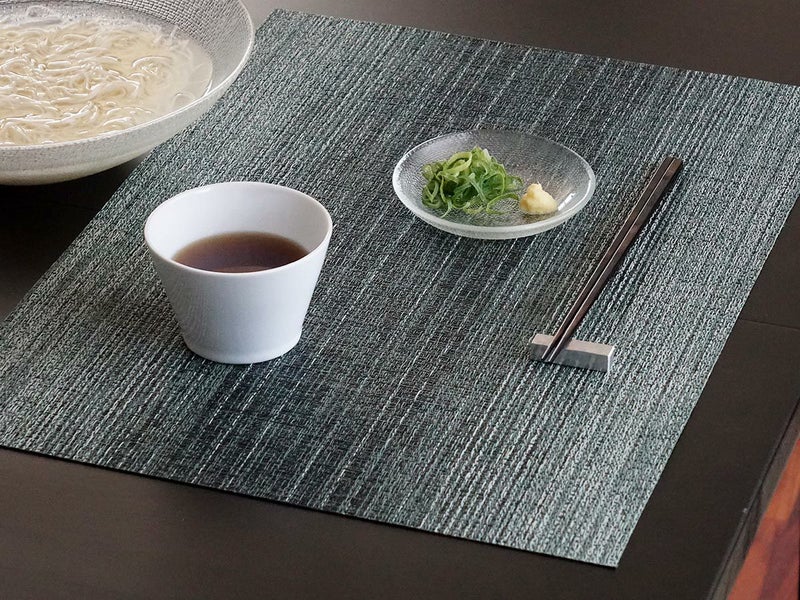 黒色のテーブルに合わせたグリーンの濃淡の絣のグラデーションのランチョンマットと素麺