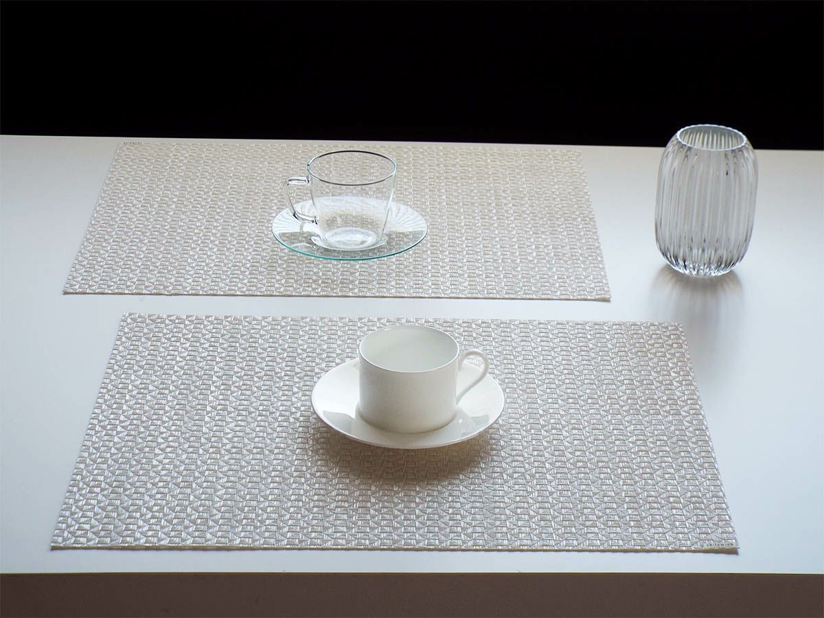 白のテーブルに映える真珠のような光沢のある白色で多面体のテクスチャーの長方形のランチョンマット